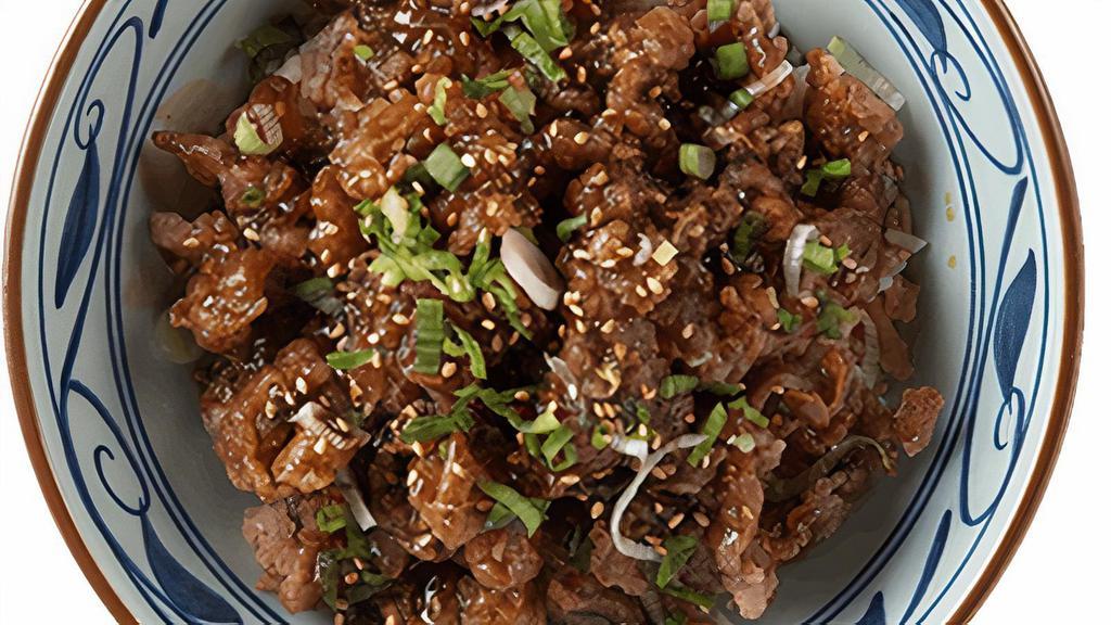 Beef Teriyaki Bowl · House made sweet mirin glaze on our crispy fried beef, served with your choice of steamed rice or udon noodles, topped with chopped scallions and toasted sesame seeds