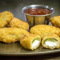 Jalapeño Poppers · Spicy jalapeños stuffed with cheese and deep fried to a golden brown.