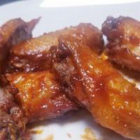 Hickory Smoked Honey B.B.Q Wings (6) · ON A BED OF FRIES. Deep-fried wings, seasoned with our Special Dry Rub, glazed with our Hous...