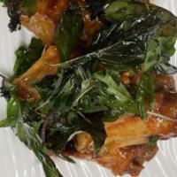 Spicy Wings of Heaven · Chicken wings tossed with house sauce topping with zest of crispy basil.