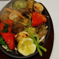 Tandoori Mixed Grill · Prawns, chicken tikka, seekh kabab, boti and fish tikka