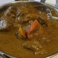 Goat Curry · A classic Indian goat dish cooked using special herbs and spices