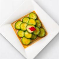 Cucumber Salad · Crisp Persian cucumbers combined with cuts of mild fresno chili peppers and sliced, fresh ga...
