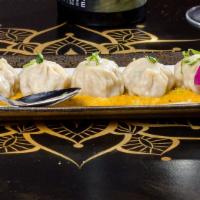 Chicken Momo · Famous Nepalese style steamed chicken dumpling served with tomato and sesame chutney.