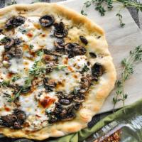 Vegan Recharge Mushroom Pizza · Vegan white pie with mushrooms and vegan cheese.
