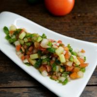 Salati Afghani · Chopped onions, hot peppers, cucumber, tomatoes, cilantro and seasoned with salt. *spicy.