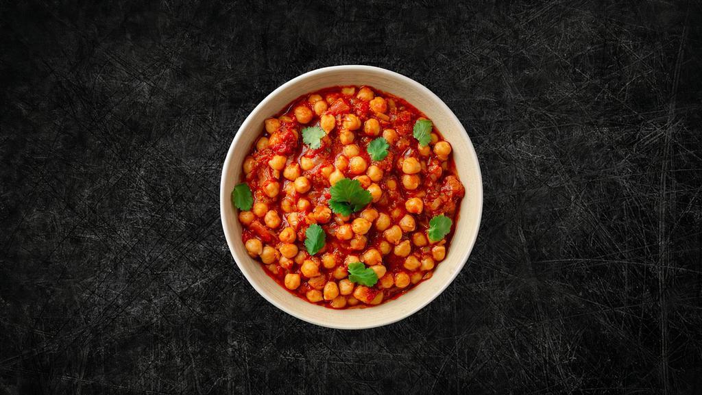Chickpea Potato Masala  · Whole chickpeas and potatoes, slow-cooked in an onion and tomato curry sauce with Indian whole spices.