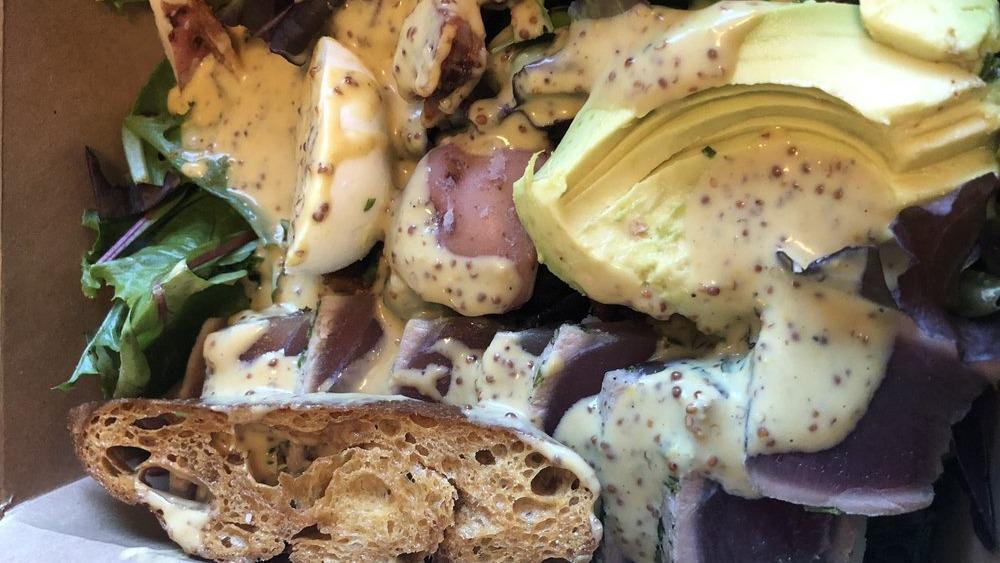 East Bay Nicoise · Seared rare ahi tuna, mixed field lettuces, candied bacon, hard-boiled egg, avocado, red potato, honey mustard dressing