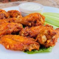 Chicken Drumettes · Spiced drumettes tossed in a chili and garlic parmesan glaze, served with ranch dressing.