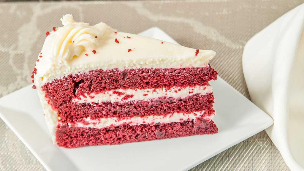 Red Velvet Cake · A red hued chocolate layer cake, filled and iced with a smooth cream cheese frosting, finished with chocolate.