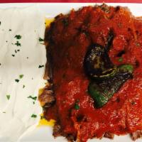 Iskender Kebab · Thinly-sliced, roasted lamb served over sliced pita covered in a tomato and butter sauce. Se...
