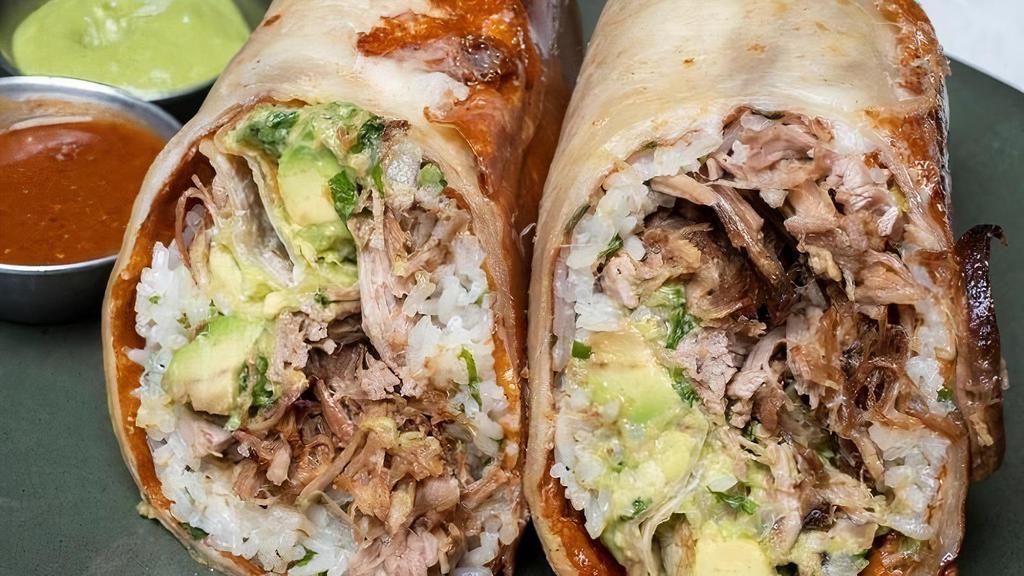 Carnitas Burrito · Flour tortilla, crispy melted cheese, traditionally braised pork, herb lime rice, and guacamole. Served with a side of jalisco salsa and avocado tomatillo salsa.