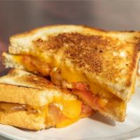 Grilled Cheese + Roasted Tomato Soup · Sharp cheddar, tomato + caramelized onions.