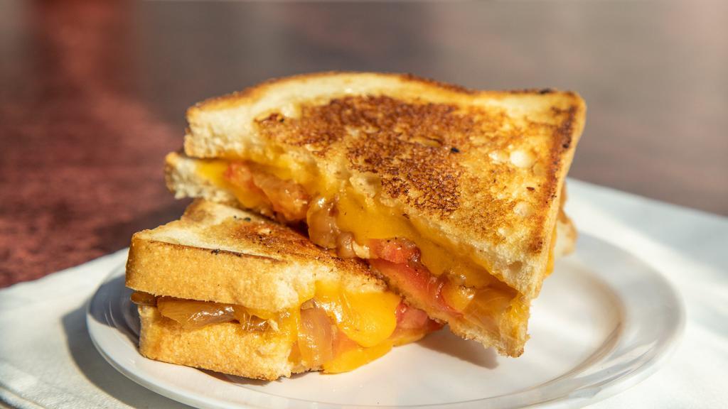 Grilled Cheese + Roasted Tomato Soup · Sharp cheddar, tomato + caramelized onions.