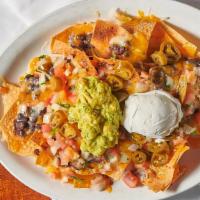 Nachos · Tortilla chips individually layered with black beans, jack and cheddar cheeses, topped with ...