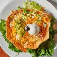 Taco Salad · Fresh lettuce topped with ground beef or chicken, beans, sour cream, guacamole, jack and che...