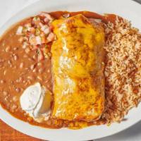 Beef Burrito · A large flour tortilla filled with our Chili Colorado beef and charro beans covered with sau...