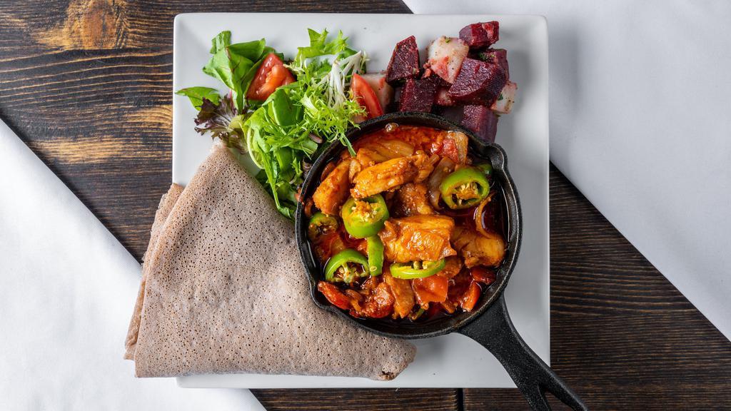 Asa Wot (Fish Goulash) · Wild-caught codfish, cooked with onion, garlic, ginger, cumin, berbere, infused with olive oil. Served with injera or rice.