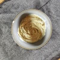Hummus · Cooked chickpeas mashed and blended with tahini, olive oil, salt, and garlic.
