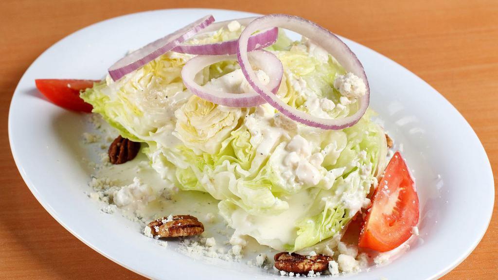 The “Iceberg Wedge” · W/ tomato, red onion, spiced pecans, & our blue cheese dressing.