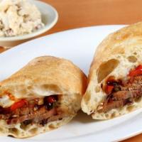 Spicy Texas Cheesesteak · Smoked texas beef brisket on a toasted hoagie roll w/ sauteed peppers, onions, provolone che...