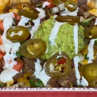 Asada Fries · Our Crisp French Fries with melted cheese, Guacamole, Sour Cream and Pico de Gallo. (Jalapen...