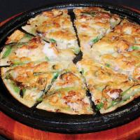 Haemul Seafood Pajun · Assorted seafood and green onion mixed pancake served on sizzling stone pot.