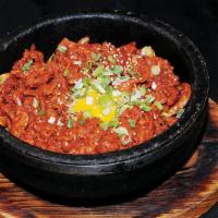 B-7. Spicy Pork Bibimbap · Spicy pork with mixed vegetable and fried egg over rice in a sizzling pot.
