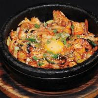 B-4. Tofu Bibimbap · Tofu with mixed vegetable and fried egg over rice in a sizzling pot.