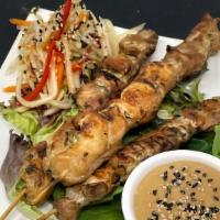 Satay of Chicken · Grilled skewers of chicken served with peanut sauce and papaya salad.