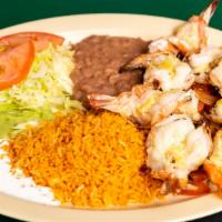 Camarones Al Mojo De Ajo · Large tiger prawns, sauteed in garlic, and mushrooms. Served with rice, beans, salad, and yo...
