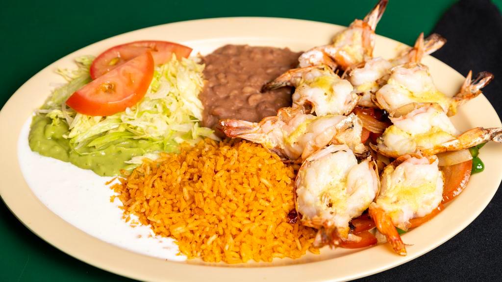 Camarones Al Mojo De Ajo · Large tiger prawns, sauteed in garlic, and mushrooms. Served with rice, beans, salad, and your choice of corn or flour tortillas.