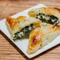 Spanakopita · Spinach and feta cheese wrapped in a puff pastry.