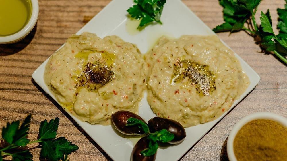 Baba Ghanoush · Chopped roasted eggplant dip, with fresh herbs, lemon juice, and olive oil.
