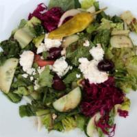 Greek Salad · Romaine hearts, tomato, onion, cucumber, feta, olives, and house dressing. Served with pita ...