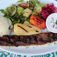 Adana Kebab Plate · Charcoal grilled minced lamb lightly spiced with parsley and onion. Served with salad, rice,...