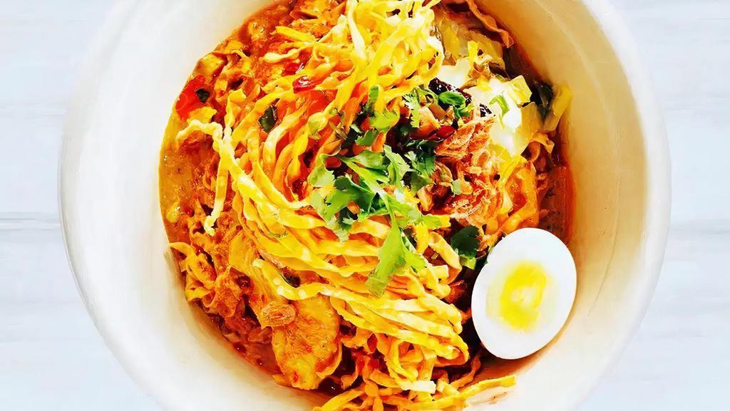Kao Soi (Noodle & Curry) · Vegan-friendly. Egg noodles in curry broth and boiled free-range egg topped with fried onion pickled mustard greens, bean sprouts, and crispy noodles.
