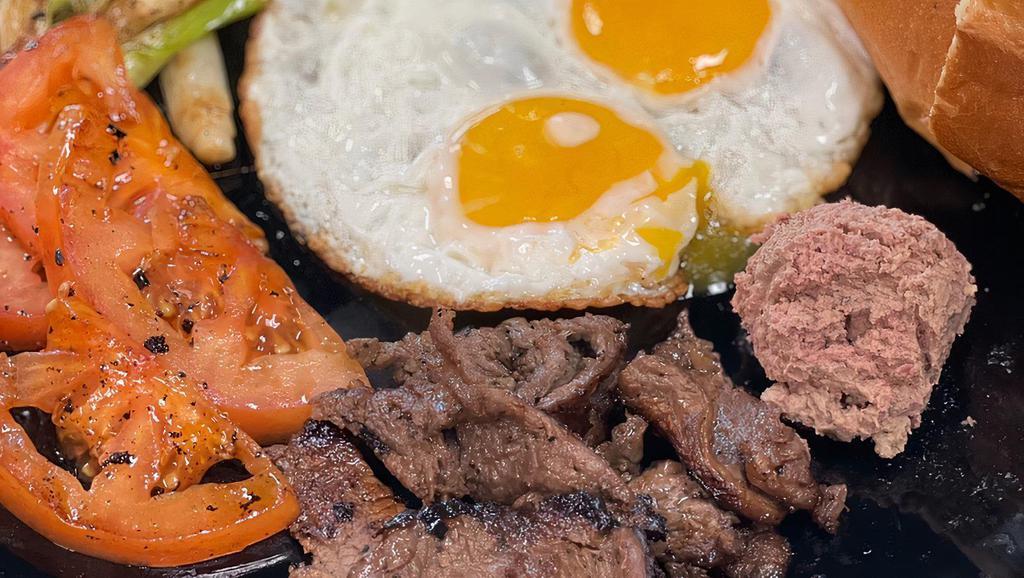 S6. Bo Ne (Vietnamese Steak and Eggs) · Served w/ two sunny side up eggs, pate, tomatoes, cucumber, and baguette.