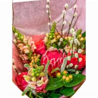 Protea Passion · Exquisite custom bouquet with exotic raspberry protea, garden roses, willow, and snapdragons.