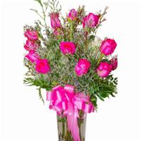 Magenta Magic · Dozen hot pink roses with misty blues in a vase.