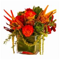 Sunset Love · A mix of red-orange roses, heliconias and amaranthus and cymbidium orchids.