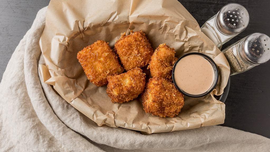 Mac & Cheese Bites · Handmade, lightly fried mac and cheese bites. Served with spicy ranch.