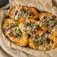 Potato Skins · Loaded with cheese, bacon, sour cream and green onions. Served with ranch.