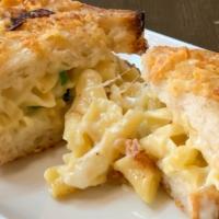 Totally Cheesy Mac Melt · creamy mac 'n' cheese, white cheddar, mozzarella, and green onions on our signature salt & v...