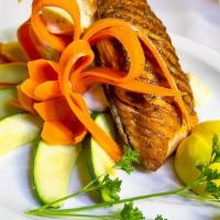 Grilled Salmon · Grilled to perfection with herb butter sauce served with mashed potatoes and steamed veggies.