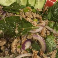 18. Larb · Choice of ground beef, chicken or pork, seasoned with spicy lime dressing, mint, onions and ...