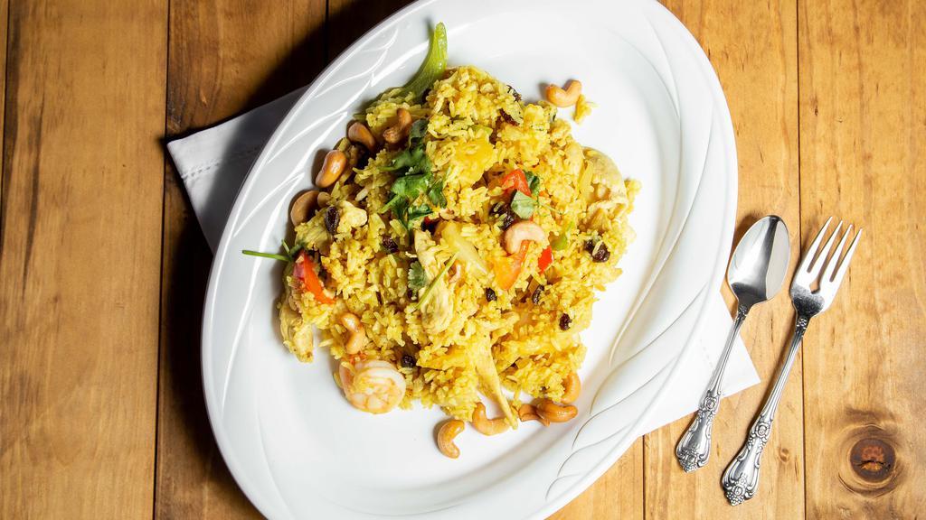 69. Pineapple Fried Rice · Fried rice with chicken, shrimp, pineapple, cashew nuts, raisin, onion and bell pepper.