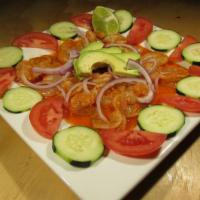 Aguachile Rojos  · RAW Shrimp tanned in lemon with red sauce (HOT) served with red onion and cucumbers.
