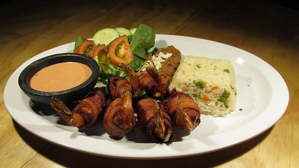 Camarones Momia · Shrimp filled with cheese, ham, jalapeno and wrapped with bacon.