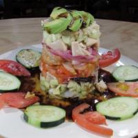 Tostada Torre · Octopus, crab, raw & cooked shrimp,
 fish ceviche, mango, avocado, cucumber, red onion.